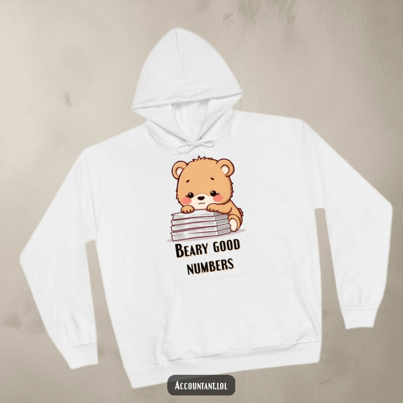 Funny hoodie with a contented bear cub smiling over a pile of spreadsheets, offering cozy comfort and a humorous, peaceful work aesthetic.