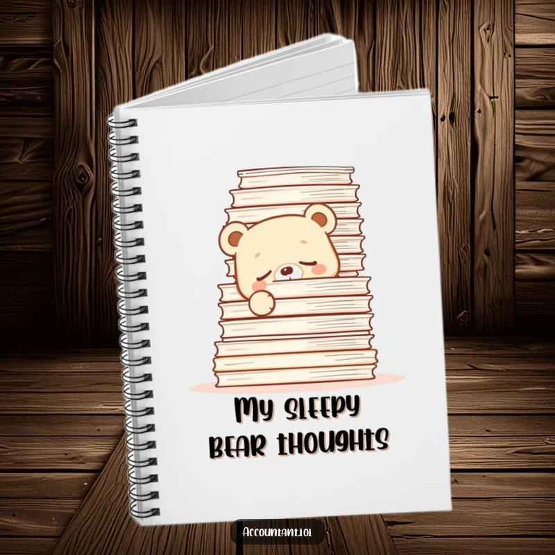 Funny Notebook with a sleepy bear cub peeking from behind papers, ideal for note-taking and humor.